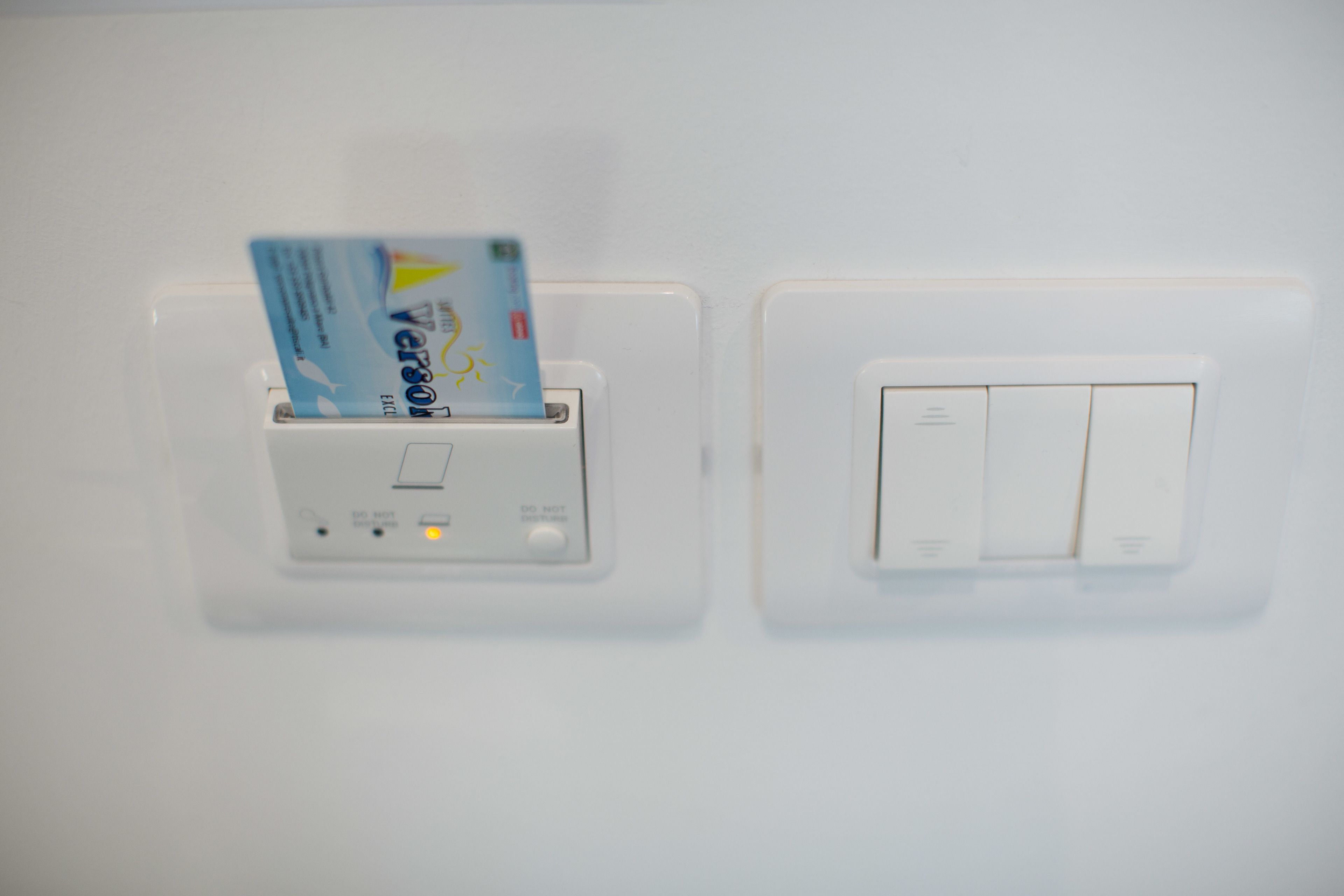 A wall-mounted card reader and a light switch.