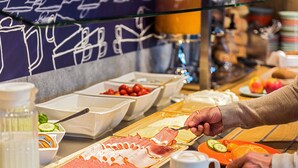 A buffet with various food options including meats, fruits, and condiments. - Ibis Budget Aachen City (Aachen)