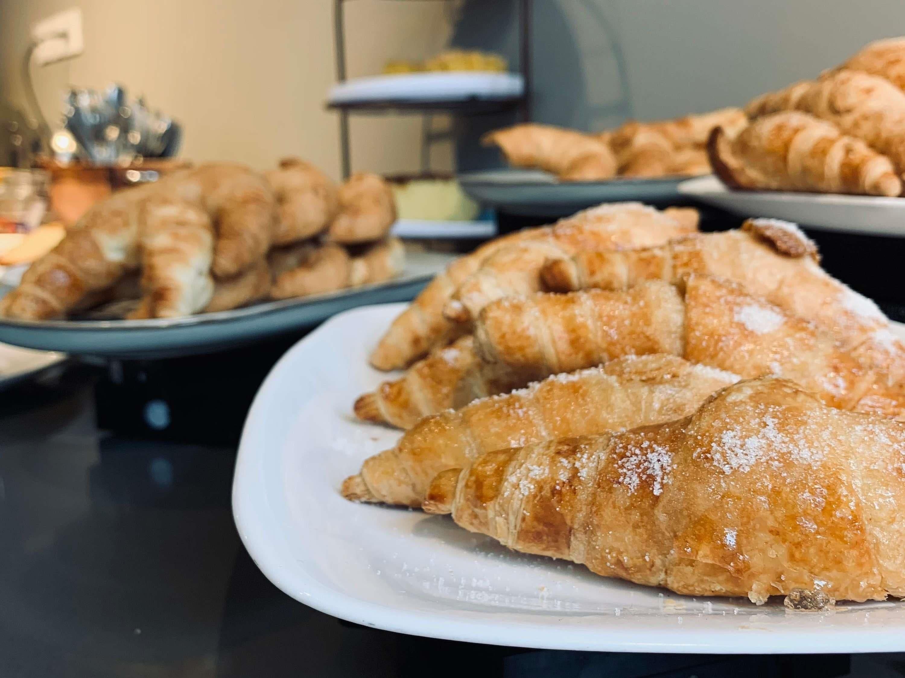 A variety of pastries displayed on plates, suggesting a bakery or cafe setting.