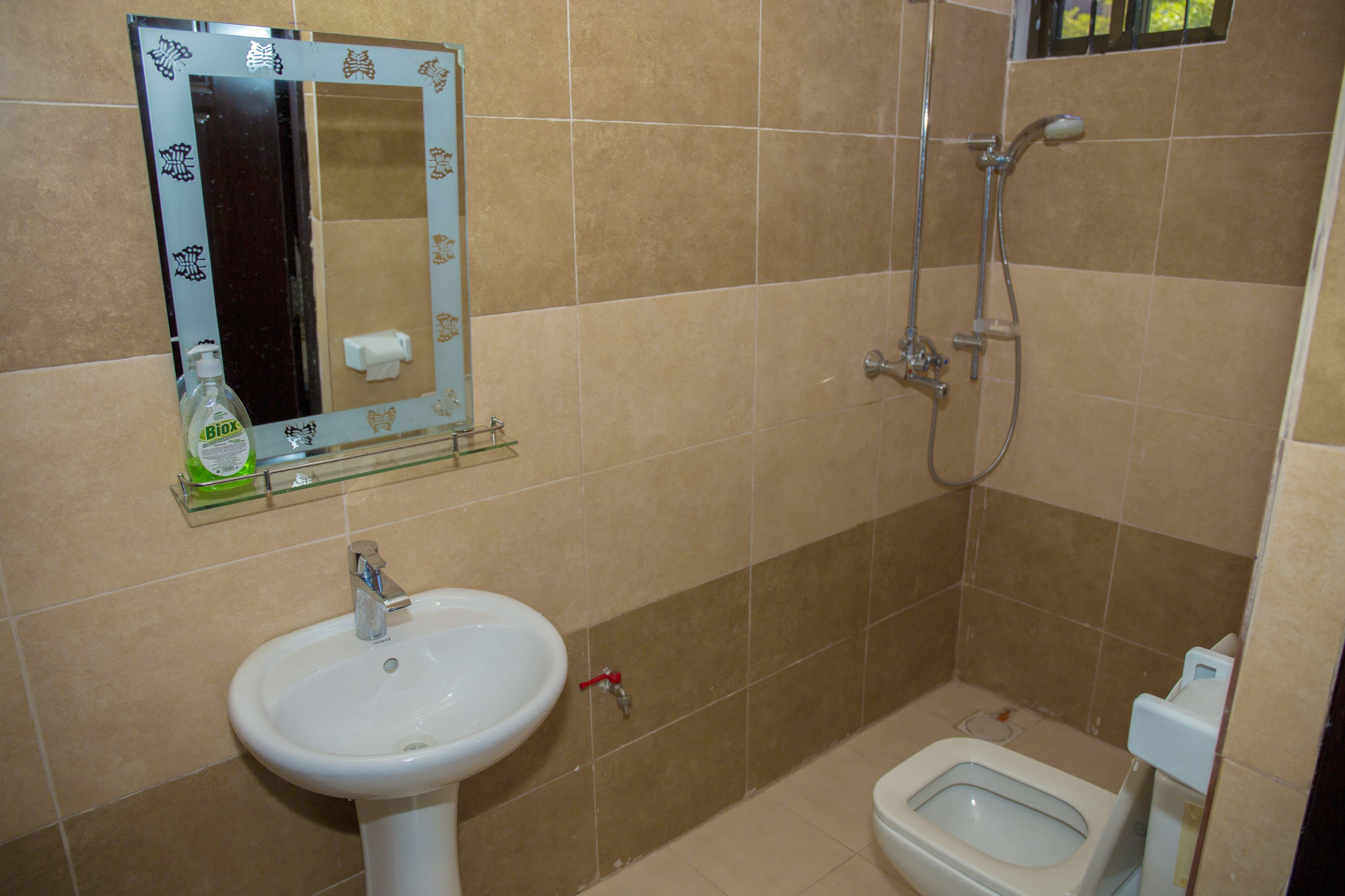 A bathroom with a sink, toilet, and shower.