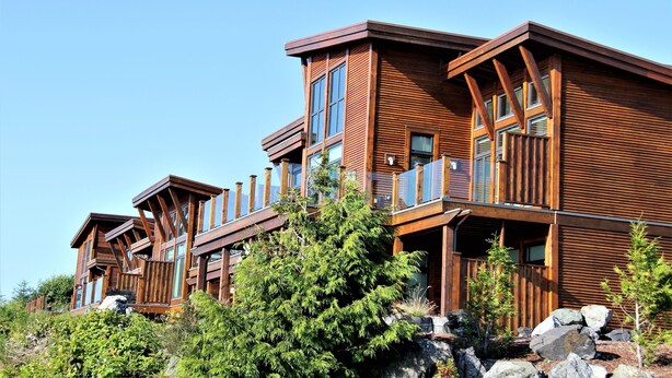 A multi-story wooden lodge with balconies and large windows. - Pacific Rim Retreat (Ucluelet)