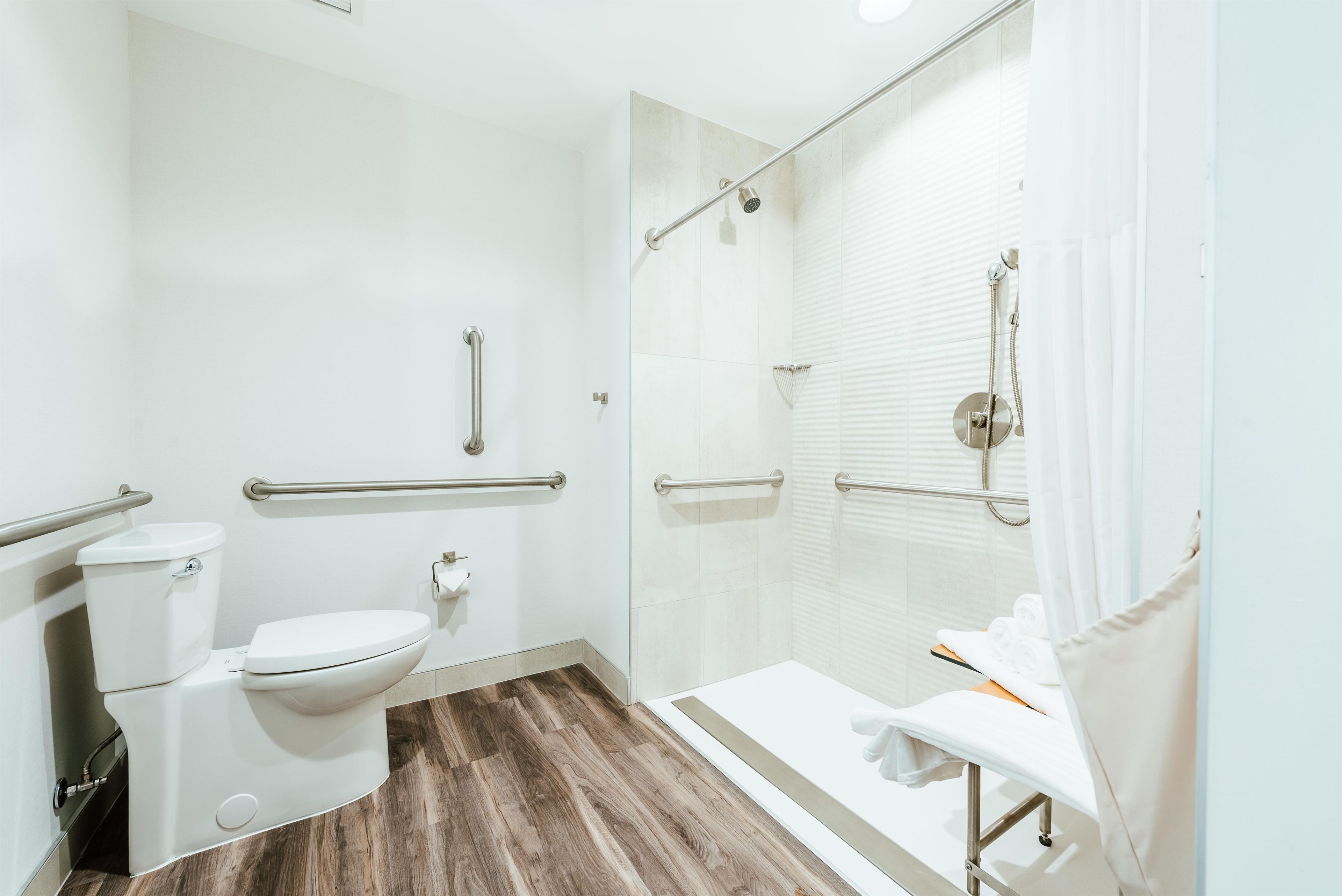 A modern bathroom with a toilet, bidet, and shower area.