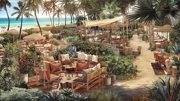 Un resort tropical con zonas de estar al aire libre, vista a la playa y un paseo cubierto.