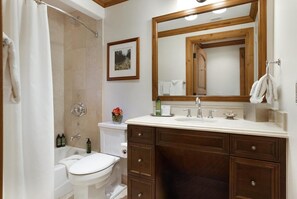 A bathroom with a shower, toilet, sink, and vanity. - Willows 202 | Luxury 2BR Vail Village (Vail)