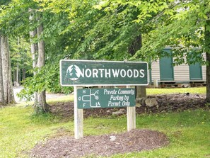 A sign for Northwoods Private Community with a parking map.