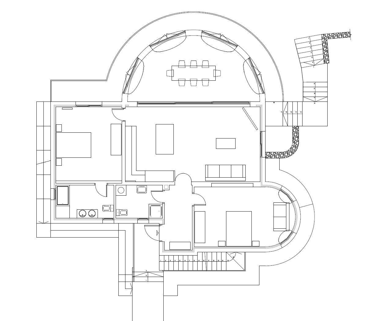 A floor plan of a hotel with a central dining area, multiple rooms, a kitchen, and a bathroom.