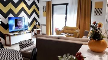 Apartment, Multiple Beds | Living area | 55-inch Smart TV with satellite channels, TV