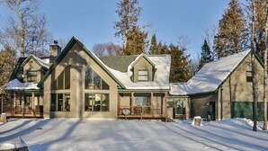 Une grande maison à étages, dotée d’un porche avant imposant et d’une allée couverte.