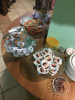 A buffet table with various food items including yogurt cups, Nutella packets, and other snacks. - RistHotel Pianura Inn (Busnago)