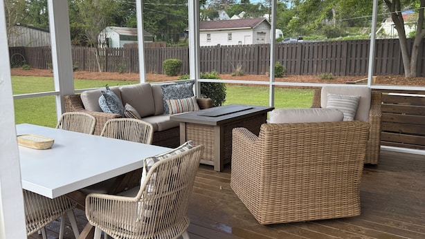 A covered patio with wicker furniture, a white table, and a ceiling fan. - Beautiful home near the Augusta National (Augusta)