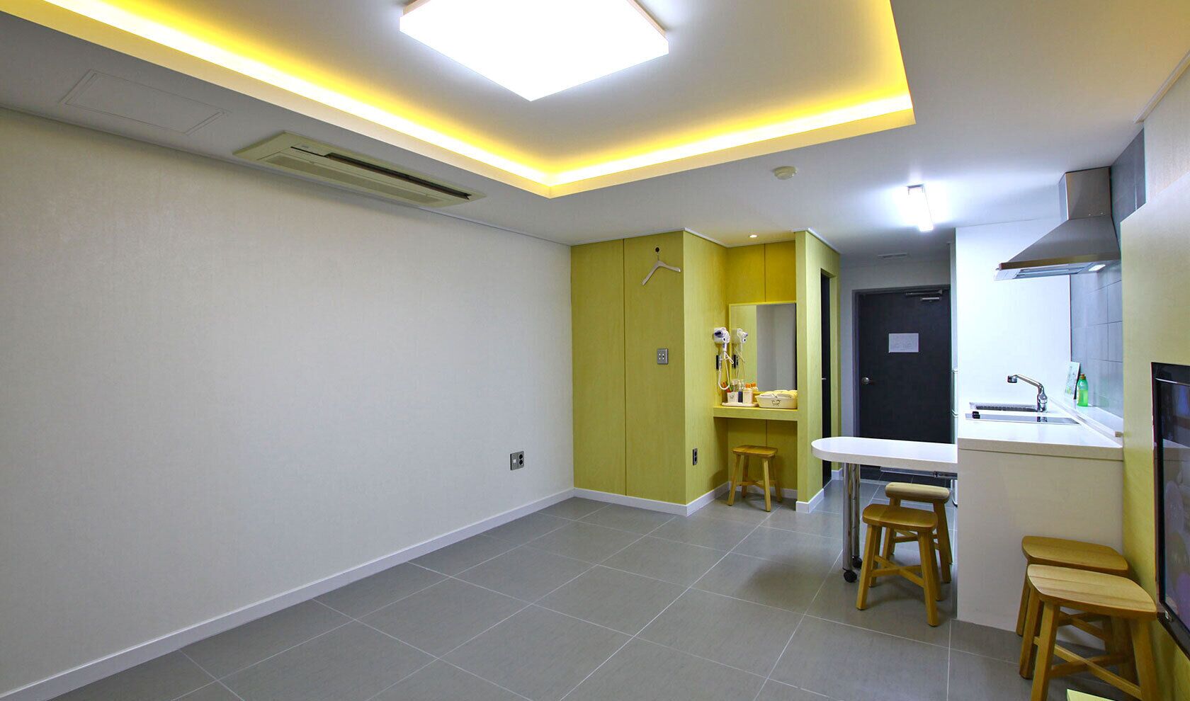 A modern kitchen with a central island, a built-in oven, and a sink.
