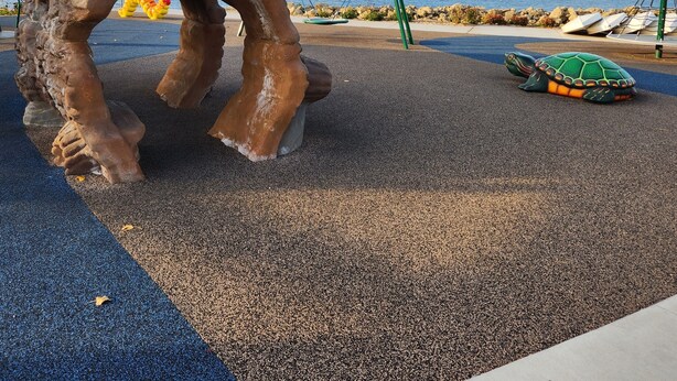 A playground with a large rock sculpture, a swing set, and a turtle sculpture. - Fantastic Large Home Right On Beautiful Lake Pepin!   (Lake City)