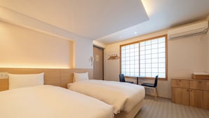 A hotel room with two beds, a desk, a chair, and a wardrobe. - RESI STAY Hachi Inn (Kyoto)