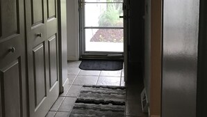 A hallway with a door leading to a bright outdoor area. - Newly renovated with lots of upgrades. (Portage)