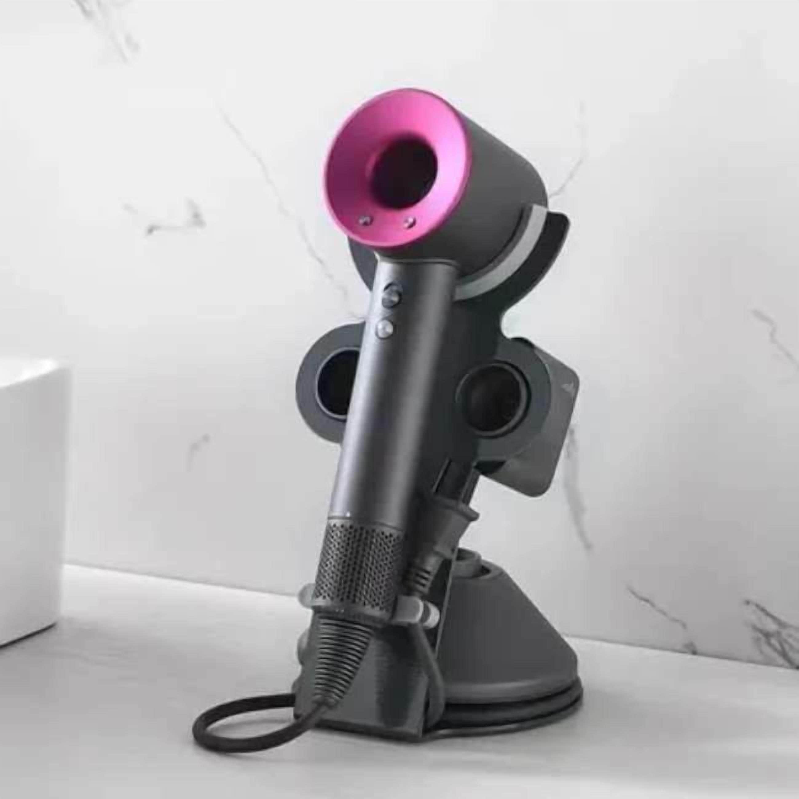 A microphone with a pink top and a flexible cable, placed on a white surface.