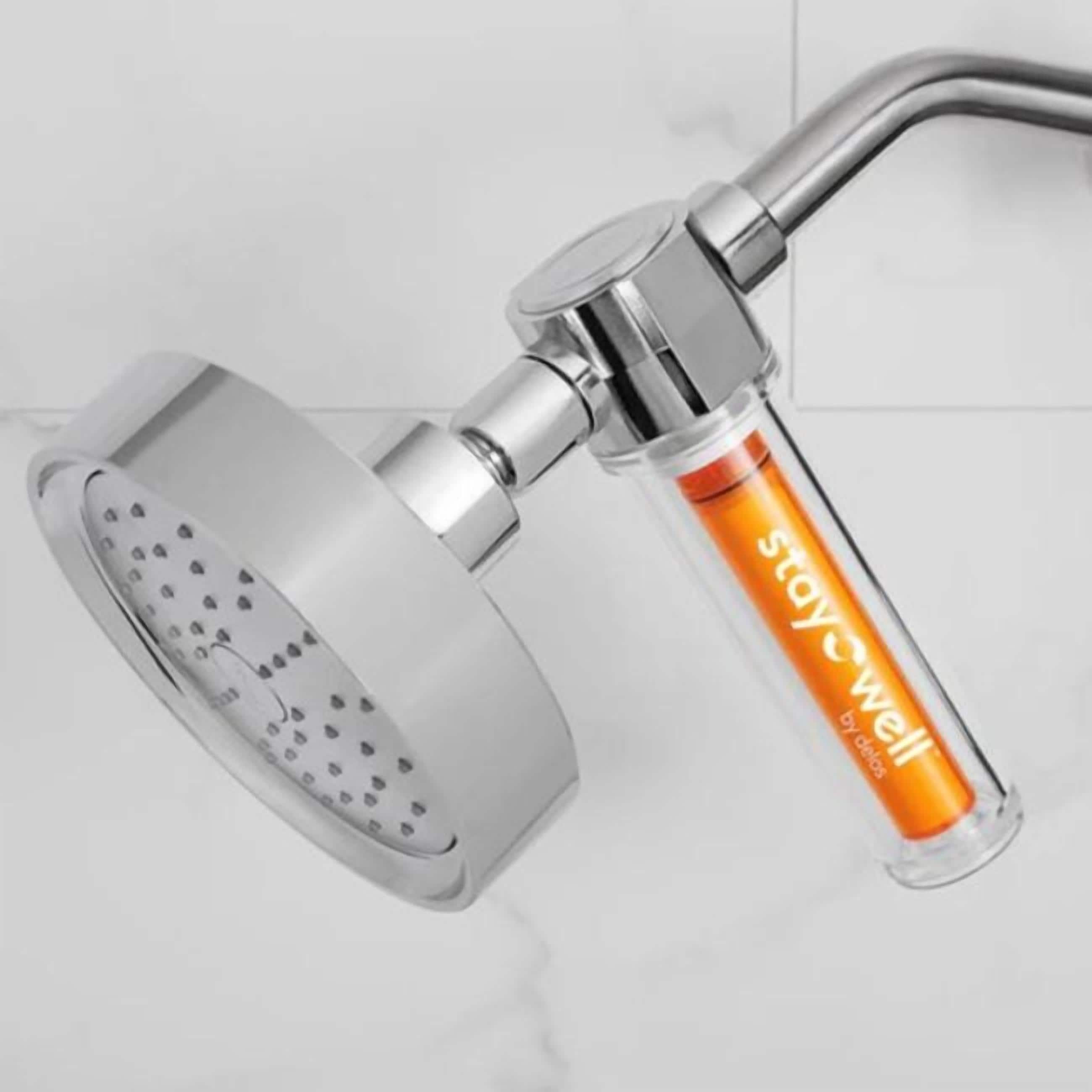 A modern shower with a curved design and a transparent soap dispenser labeled "staywell".