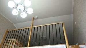 Eine Treppe mit Holzhandlauf und schwarzen Spindeln.