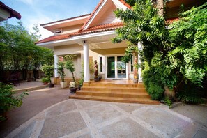 Enjoy a serene retreat on this tranquil property, surrounded by lush greenery and a peaceful neighborhood.