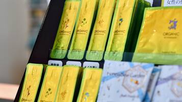 A display of organic facial lotions in yellow packaging.