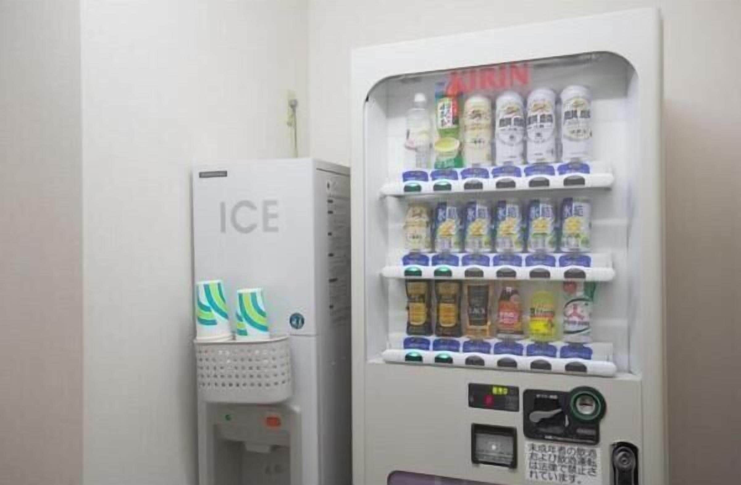 A vending machine with multiple beverage options and a separate ice dispenser.