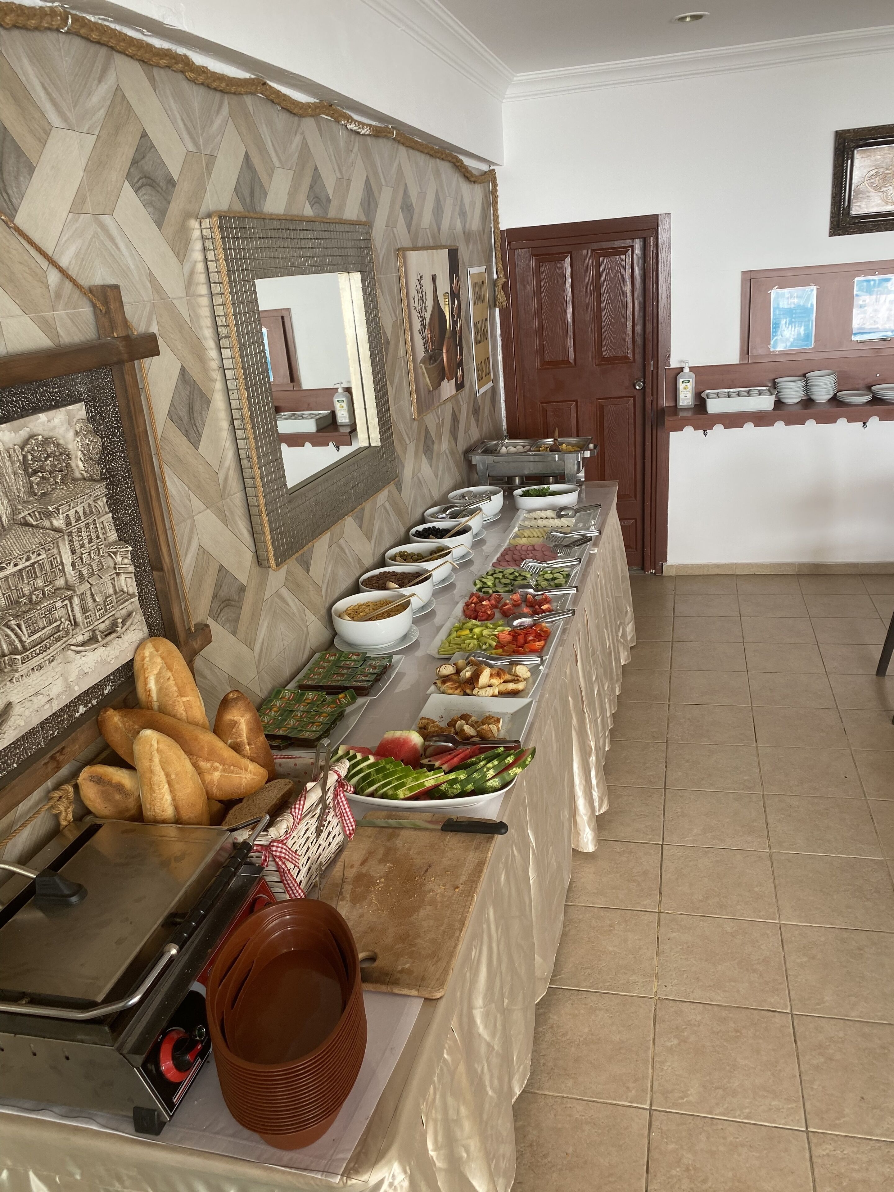 A buffet setup with various food items and utensils.