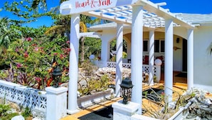 A white gazebo with a sign reading "Heart & Soul" in a tropical garden setting. - Ocean Views, Private Pool, and Lush Botanical Garden  (Governor's Harbour)