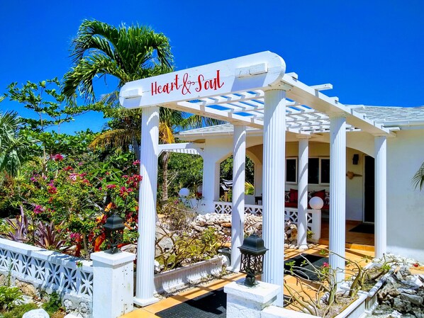 A white gazebo with a sign reading "Heart & Soul" in a tropical garden setting. - Ocean Views, Private Pool, and Lush Botanical Garden  (Governor's Harbour)