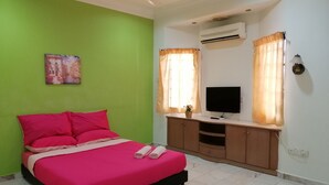 A bedroom with a bed, a TV, an air conditioner, and a window with curtains. - StayWonderful01 Kota Laksamana (Malacca City)