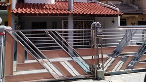 A building with a tiled roof, a staircase, and a security gate. - StayWonderful01 Kota Laksamana (Malacca City)