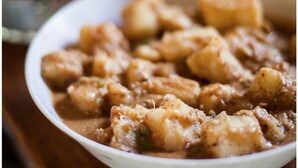 A bowl of food with a creamy sauce and chunks of meat. - Ngerengere River Eco camp (Ubena Bwawani)