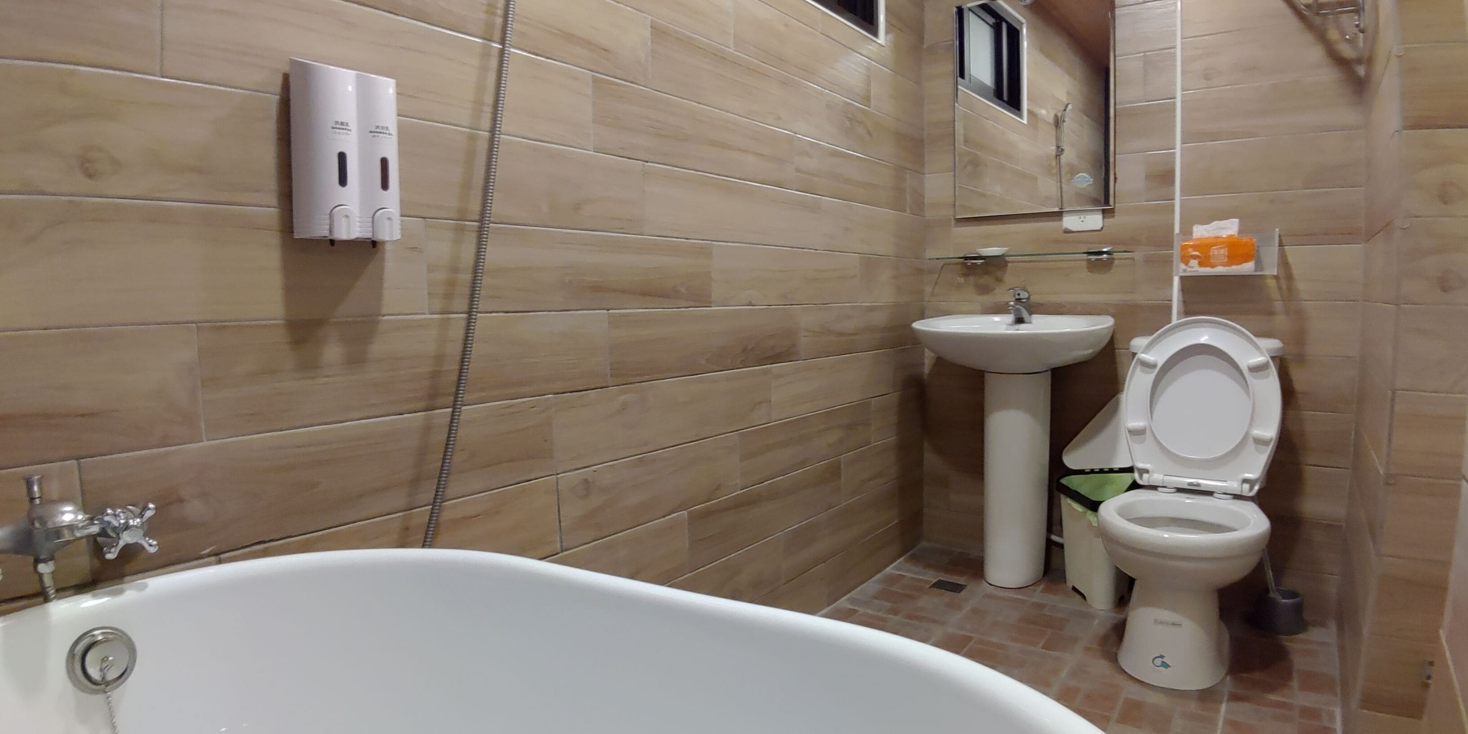 A bathroom with a bathtub, sink, and toilet.