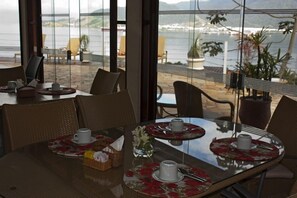 Enjoy a meal with a breathtaking view of the coastal landscape from this dining area.
