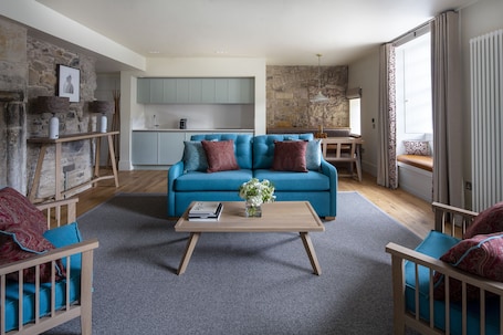 Deluxe Two Bedroom Apartment | Living room | Flat-screen TV