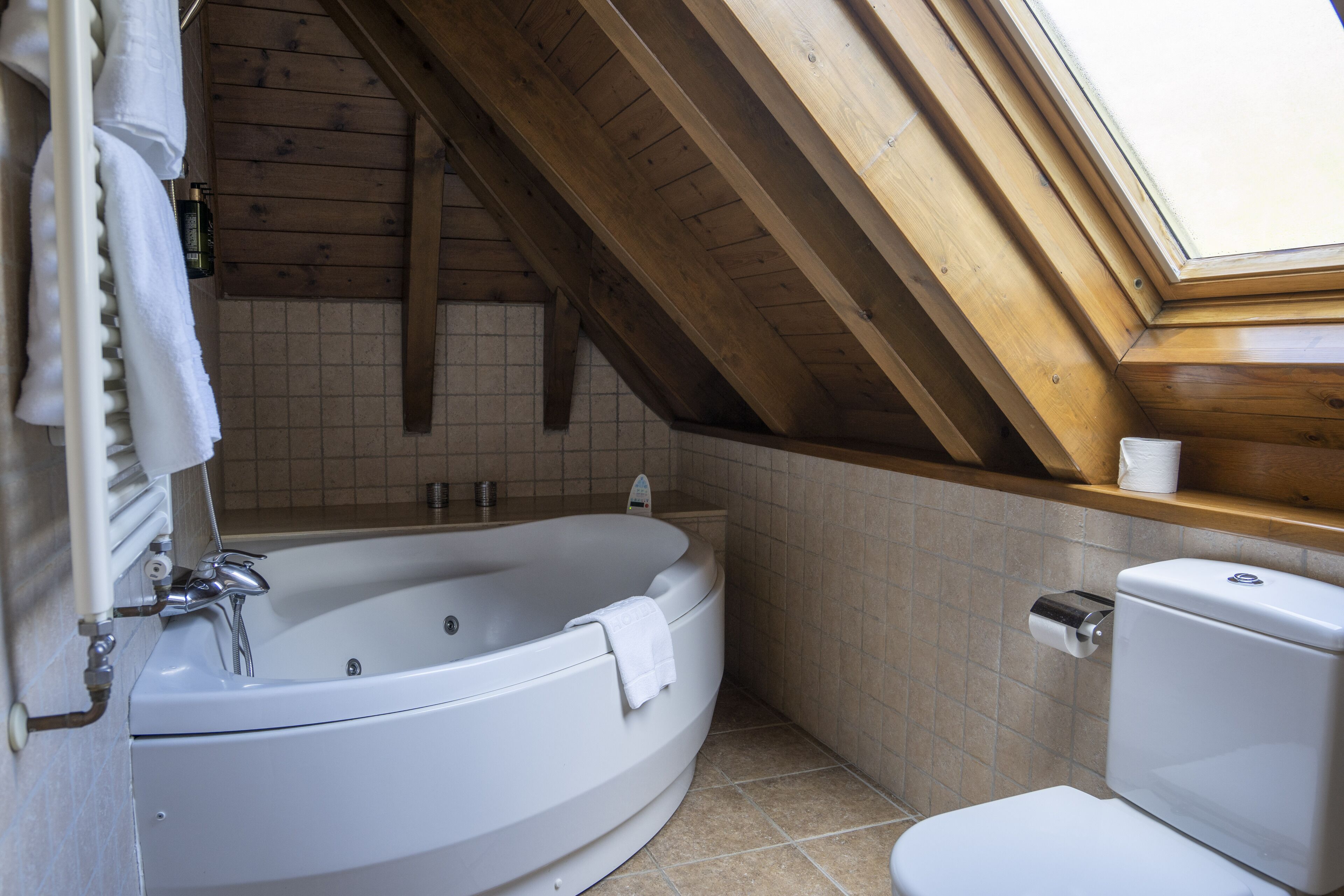 junior suite, hot tub | bathroom | deep-soaking bathtub, free toiletries, hair dryer, towels