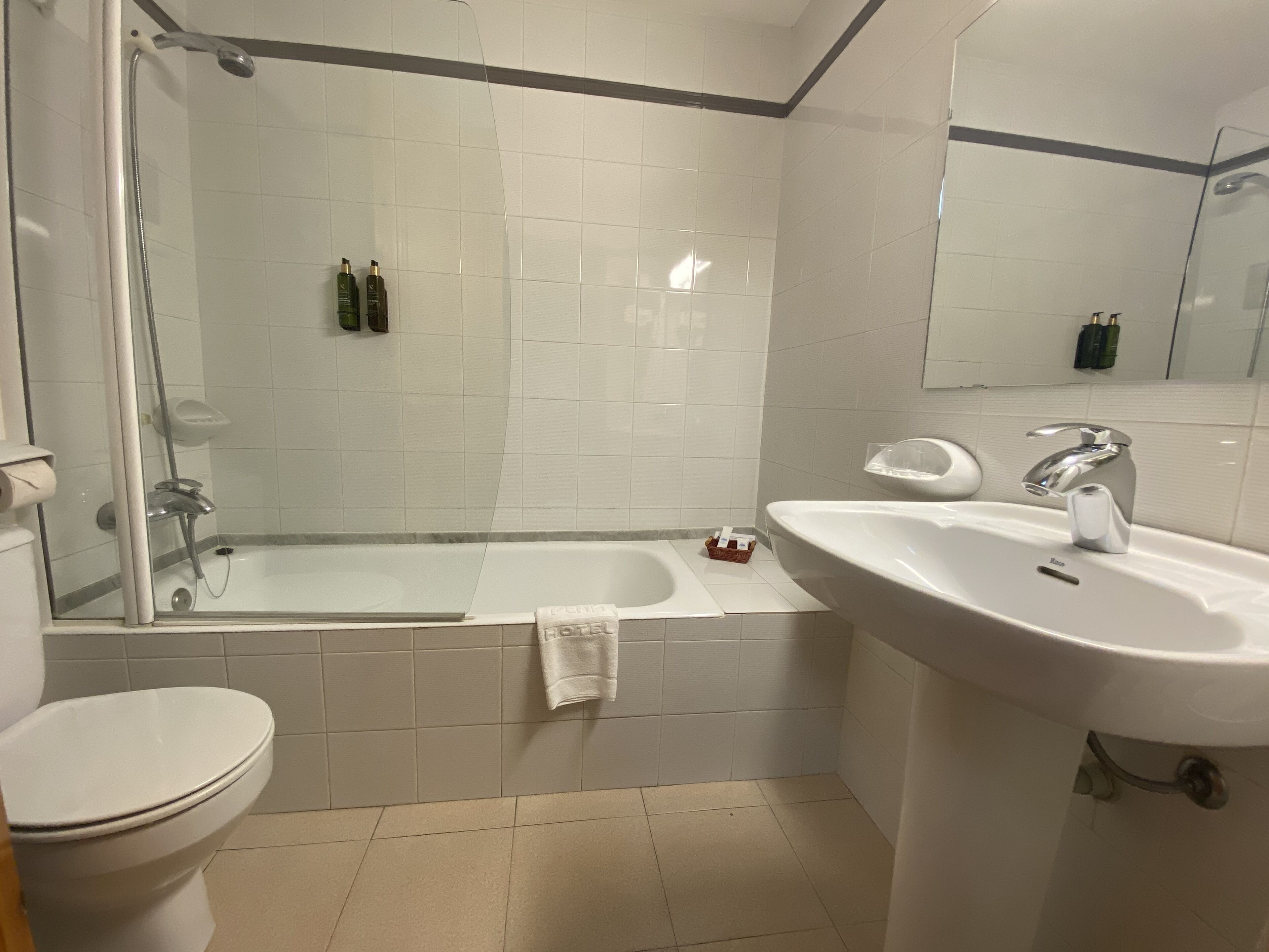 A bathroom with a bathtub, a sink, and a toilet.