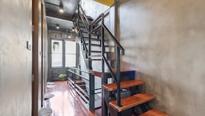 A staircase with wooden steps and metal railings leading to an upper level. - OYO 685 Am Bed Hostel (Bangkok)