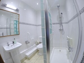 A modern bathroom with a glass-enclosed shower, a sink, and a toilet. - St Columba Hotel (Isle of Iona)