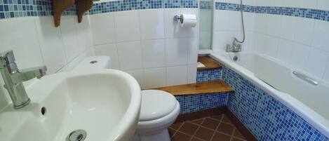 A bathroom with a white sink, toilet, and bathtub.