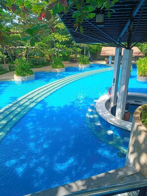 Outdoor pool, pool loungers, lifeguards on site