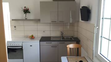 Apartment, Sea view | Private kitchen | Fridge, stovetop, coffee/tea maker, cookware/dishes/utensils