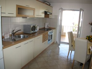 Apartment, Terrace | Private kitchen | Fridge, microwave, stovetop, electric kettle - Apartments Bareta (Trogir)
