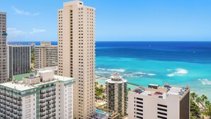 A high-rise hotel with a rooftop pool, ocean view, and adjacent beach. - Ocean-Diamond Head Views Condo at Pacific Monarch Hotel Steps to the Beach (Honolulu)