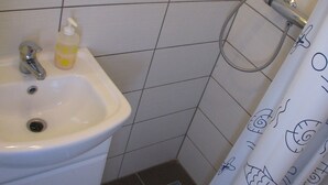 A bathroom with a sink, a shower, and a toilet. - Apartment Noa (Kastela)