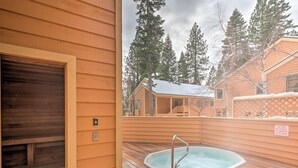 A wooden deck with a hot tub, a wooden door, and a sign indicating no food or smoking in the spa area. - Lake Tahoe Corner Condo w/ Hot Tub, Beaches Nearby (Incline Village)