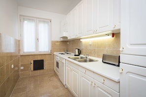 Enjoy cooking in this well-equipped kitchen with a stove, oven, and sink.