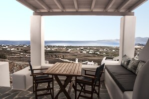 Enjoy a tranquil moment on this outdoor space with a view of the sea and surrounding coastal landscape.
