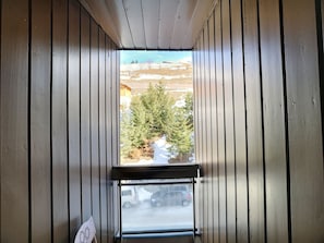 Enjoy the serene views of the surrounding trees from this balcony.