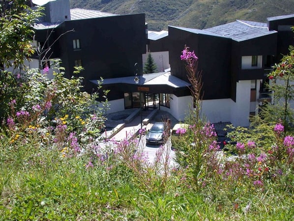Residents enjoy a serene setting surrounded by lush greenery and flowering plants.