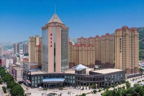 A high-rise building with a prominent tower, surrounded by other residential buildings.