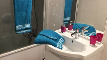 Combined shower/tub, hair dryer, towels, soap